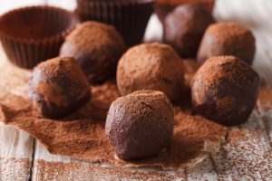 Chocolate Cashew Truffles with Cacao Powder on Wooden Table | Vitacost.com/blog