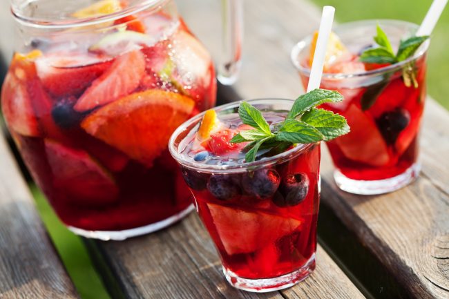 Non-Alcoholic Recipe for Sangria Non-Alcoholic Sangria with Berries & Oranges n Pitcher with 2 Glasses on Wood Table | Vitacost.com/blog