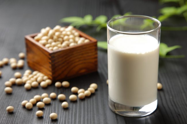Glass of Non-Dairy Soy Milk with Soybeans on Dark Background | Vitacost.com/blog