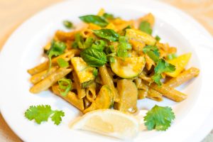 Red Lentil Penne Pasta with Creamy Coconut Curry Sauce on White Plate | Vitacost.com/blog