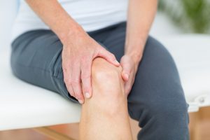 Close-up of Woman Holding Knee Because She Needs Bone Healing Recovery Food | Vitacost.com/blog