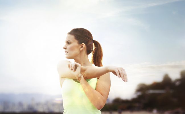 Woman Stretches Triceps During Active Rest Day | Vitacost.com/blog