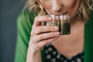 Woman Drinking Green Juice as Part of Detox Plan | Vitacost.com/Blog