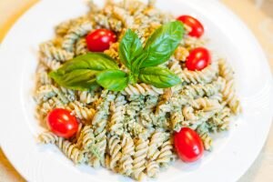 Simple Hemp Pesto Pasta with Fresh Basil and Cherry Tomatoes on White Plate | Vitacost.com/blog