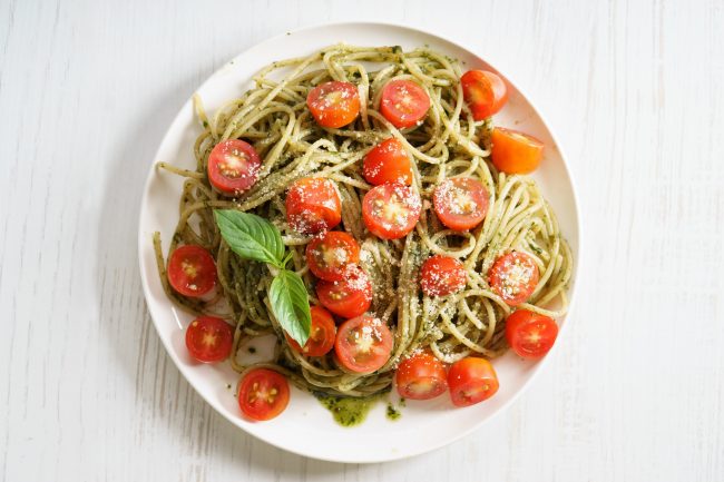 Pesto Pasta with Garlic-Infused Olive Oil Pasta with Pesto Sauce & Cherry Tomatoes on White Plate #recipe| Vitacost.com/blog