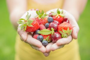 Woman Holding Assorted Berries Low on Glycemic Index in Cupped Hands | Vitacost.com/blog