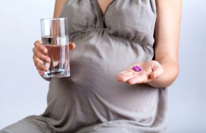 Woman Focused on Pregnancy Nutrition Taking Prenatal Vitamins | Vitacost.com/blog