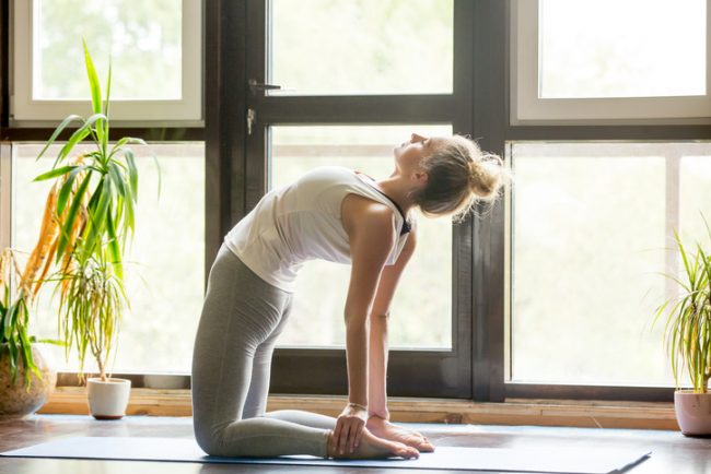 Woman at Home Practicing Yoga to Relieve Stress, Depression & Anxiety | Vitacost.com/Blog