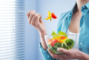 Woman Eating Vegetable-Packed Salad to Support Good Health | Vitacost.com/blog