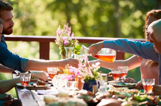 Zero-Waste Living Summer Party Guests Enjoying Outdoor Meal on Patio | Vitacost.com/blog
