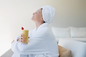 Woman in Bathrobe Enjoying the Health Benefits of Collagen With a Supplement-Enhanced Smoothie | Vitacost.com/blog