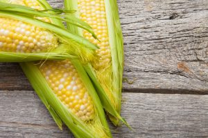 Corn on the Cob on Wooden Table to be Avoided by Those With a Corn Allergy | Vitacost.com/blog