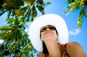 Woman Wearing Hat and Sunglasses to Protect Eyes from Sun Damage | Vitacost.com/blog