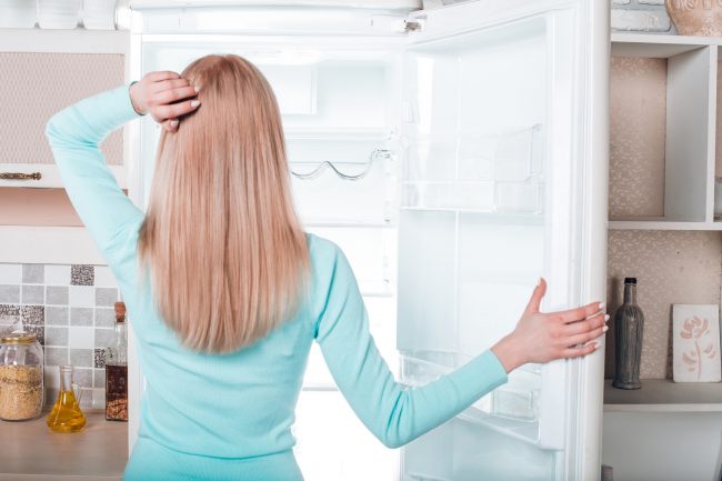Blonde Woman Opens Empty Fridge & Thinks About a Post-Vacation Detox | Vitacost.com/blog