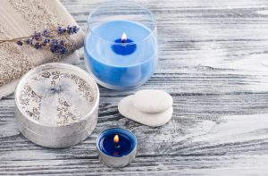 Assortment of Blue Soy Candles and Natural Air Fresheners on Wooden Table | Vitacost.com/blog