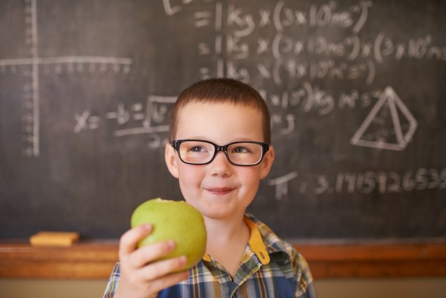 Little Boy Holds Apple Snack in Front of Chalkboard to Show His Healthy Kids Nutrition Habits | Vitacost.com/blog