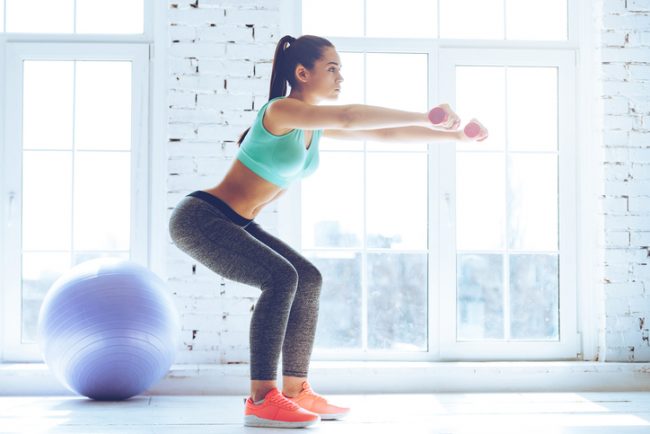Proper Squat Form + 6 Exercises You're Doing Wrong Woman Performing Deep Squat with Safe Form | Vitacost.com/Blog