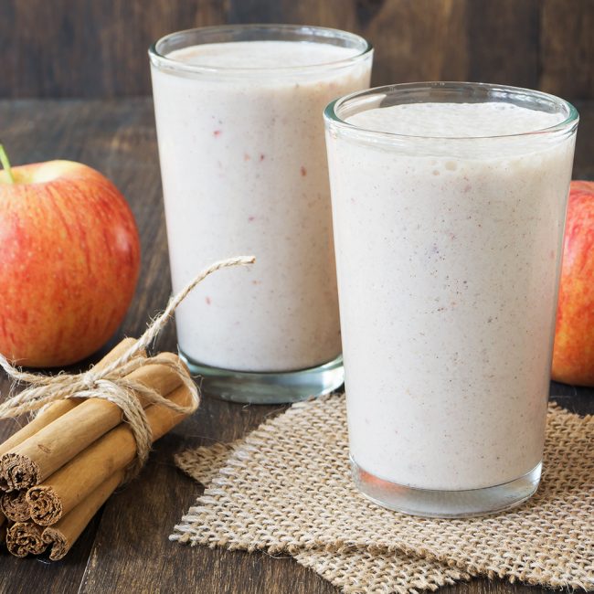 2 Glasses Full of Apple Pie Smoothie with Apple & Cinnamon Sticks on Table | Vitacost.com/blog
