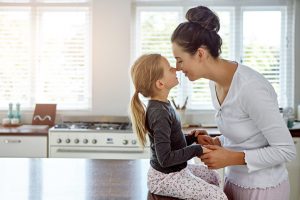 Mother & Child in Kitchen Playfully Touching Noses in Stress-Free Morning Routine | Vitacost.com/blog