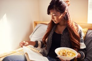 Female College Student in Dorm Studying Eating Healthy Meal | Vitacost.com/Blog