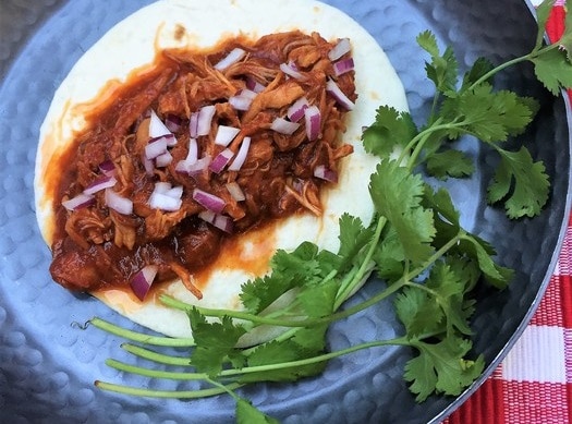 Slow-Cooked-Made Shredded Maple-Chipotle Chicken on Flour Tortilla Garnished with Onions and Cilantro | Vitacost.com/Blog