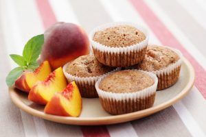 Gluten-Free Peach Muffins on Plate with Peach Slices | Vitacost.com/blog