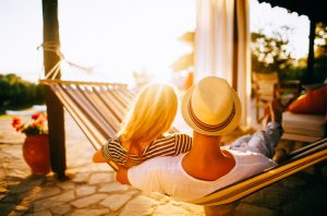 Couple in Hammoack Embracing Hygge in the Summer as Sun Sets | Vitacost.com/blog