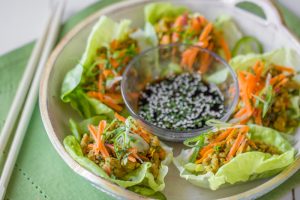 Ground Mesquite Turkey Lettuce Wraps on Plate with Soy Sauce & Sesame Seeds | Vitacost.com/blog