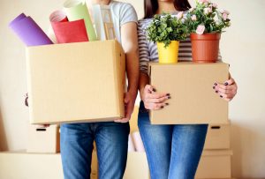 Couple Moving to a New City Holding Boxes Packed With Belongings | Vitacost.com/blog