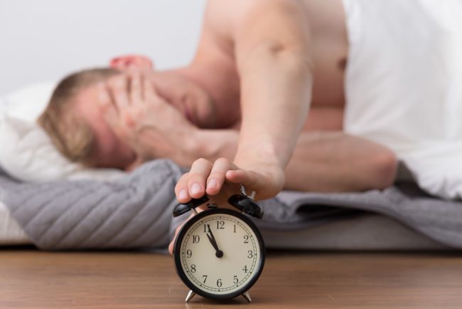 College Student Unable to Wake Up and Hitting Snooze Button on Clock After Binge Drinking | Vitacost.com/blog