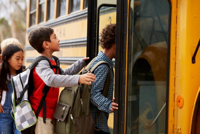 Elementary School Students Getting on to School Bus with Healthy School Supplies | Vitacost.com/Blog
