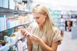 Woman Reads Cosmetic Ingredients on Beauty Products to Help Avoid Contact Dermatitis | Vitacost.com/blog