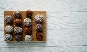 Wood Board Has a Variety of Chocolate Balls, Showing Different Version of Cereal Recipes | Vitaocst.com/blog