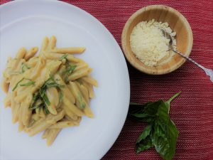 White Bowl of Butternut Squash Sauce Over Penne with Basil Leaf & Vegan Parm on the Side | Vitacost.com/blog