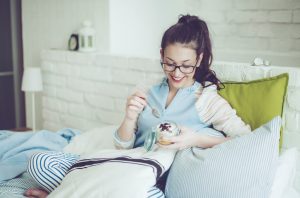 Woman Eating Parfait Breakfast to Increase Daily Fiber Intake | Vitacost.com/blog