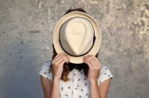 Woman With Introverted Personality Style Hiding Behind Hat | Vitacost.om/blog