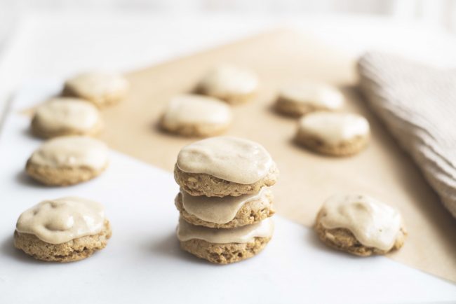 Healthy Pumpkin Cookies with Icing  3 Healthy Pumpkin Iced Cookies Stacked with Cookies on Parchment in Background | Vitacost.com/blog