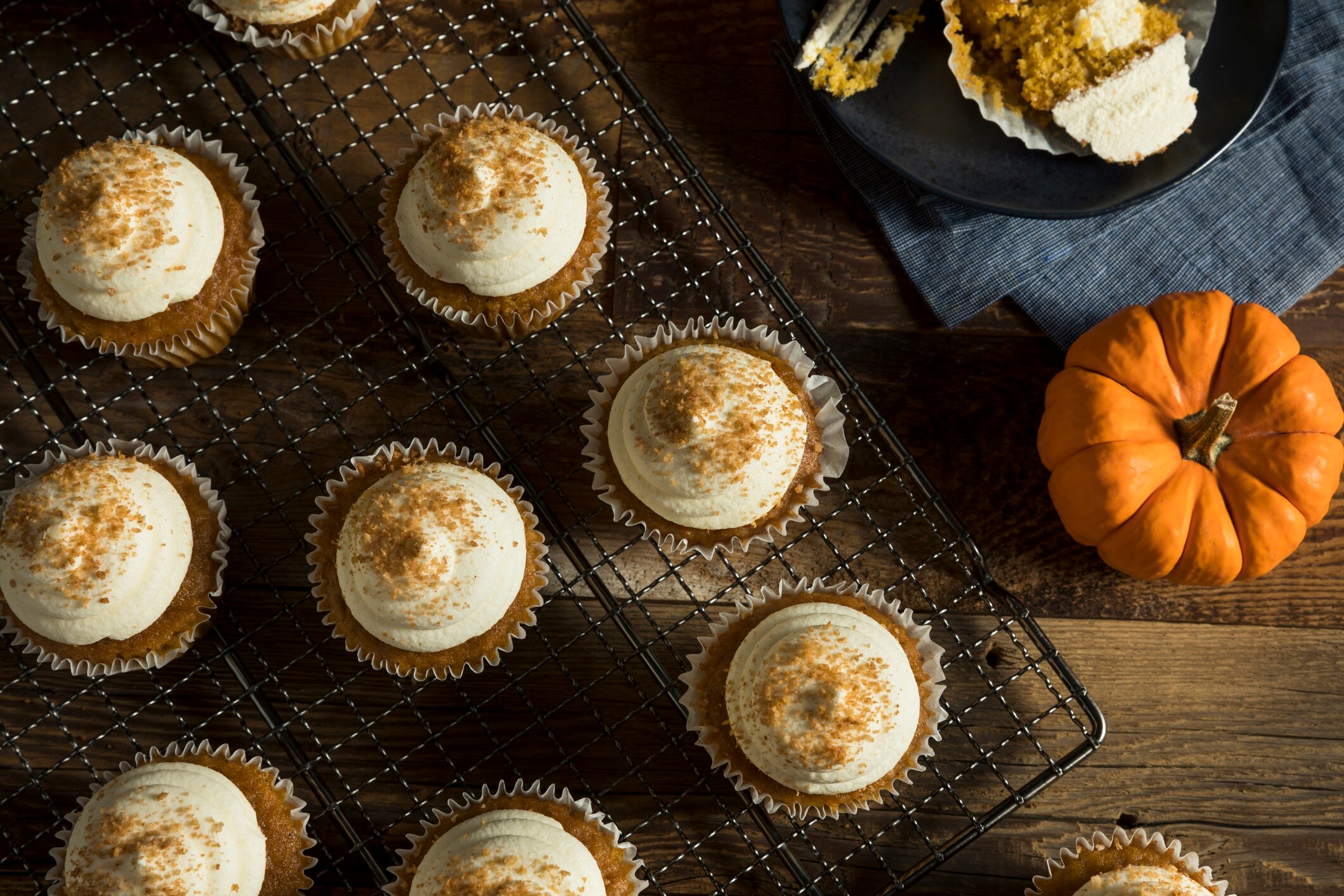 4-Ingredient Pumpkin Cream Cheese Frosting Homemade Pumpkin Cream Cheese Frosting on Cupcakes on Wire Rack with Mini Pumpkins #recipe | Vitacost.com/blog