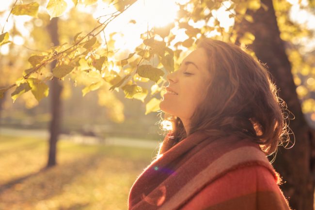 Woman in Park Surrounded by Trees Practicing Self Care | Vitacost.com/Blog