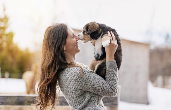 Woman Happily Holding Rescue Dog from Animal Adoption Shelter | Vitacost.com/blog