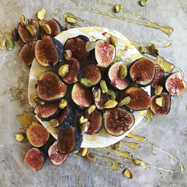 Baked Brie with Figs & Honey  White Plate Full of Baked Brie, Covered in Fresh Fig Slices, Honey & Pistachios | Vitacost.com/blog