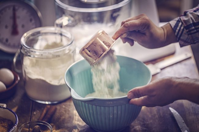 Cross Contamination in Your Kitchen? 4 Tips to Avoid It Woman’s Hands Using Copper Measuring Cup to Pour Flour into Teal Bowl Could Be Cross Contamination of Food | Vitacost.com/blog