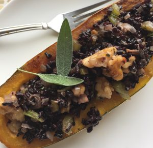 A Roasted & Stuffed Delicata Squash with Black Forbidden Rice on White Plate | Vitaocst.com/blog