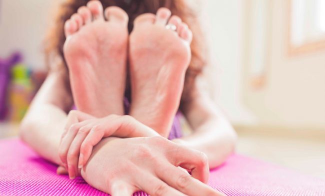 Woman Using Pillow in Lap for Supported Forward Fold | Vitacost..com/Blog
