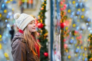 Woman Enjoying Healthy Holidays While Window Shopping at Decorated Storefront | Vitacost.com/blog