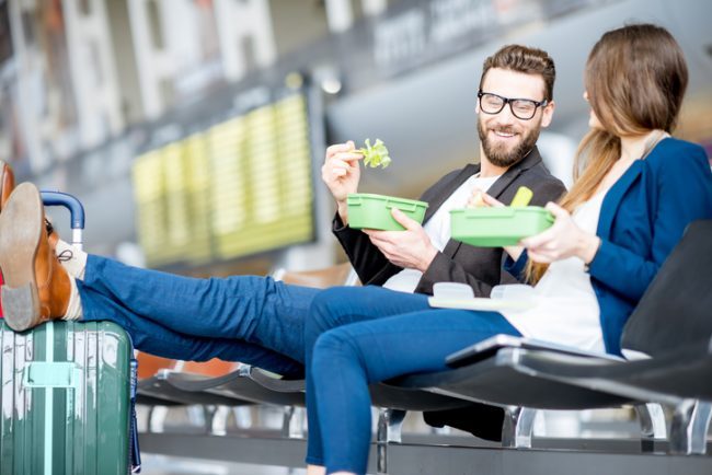 Couple Sitting in Airport Terminal Eating Healthy Homemade Food | Vitacost.com/Blog