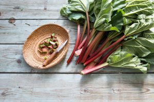 Rhubarb Leaves on Wood: One of 7 Poisonous Foods if Eating Raw | Vitacost.com/blog
