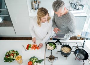 Overhead View of Couple Following Vegetarian Diet Cooking Dinner in White Kitchen | Vitacost.com/blog