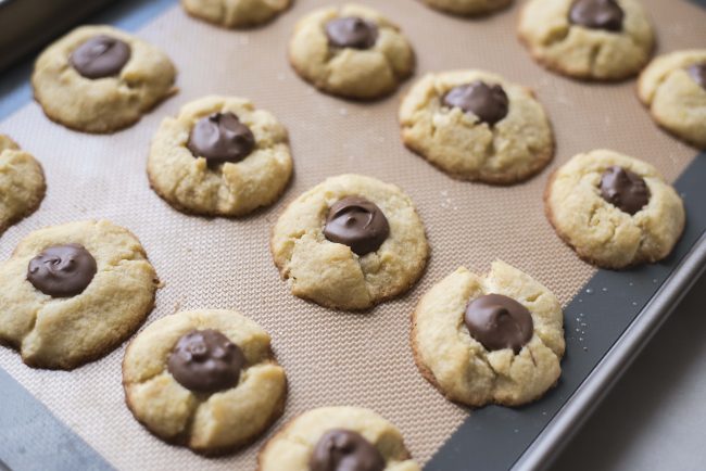 Chocolate Toffee Thumbprint Cookies on Baking Sheet Lined with Parchment Paper | Vitacost.com/blog