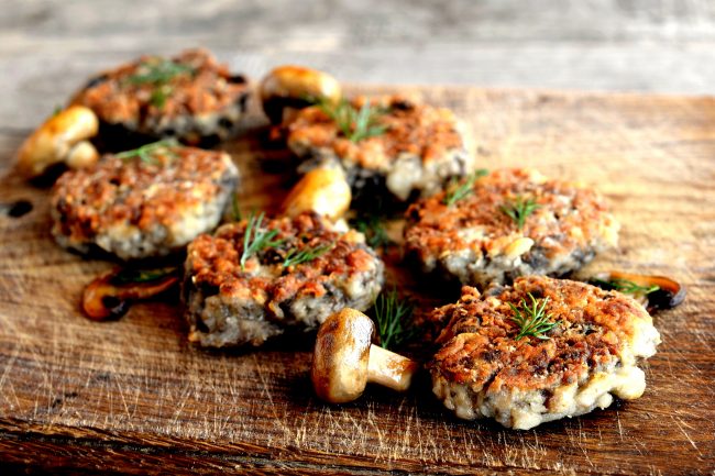 Mushroom Burgers on Wood Cutting Board Could Be Made with Mycoprotein – Learn More About What it is | Vitacost.com/blog